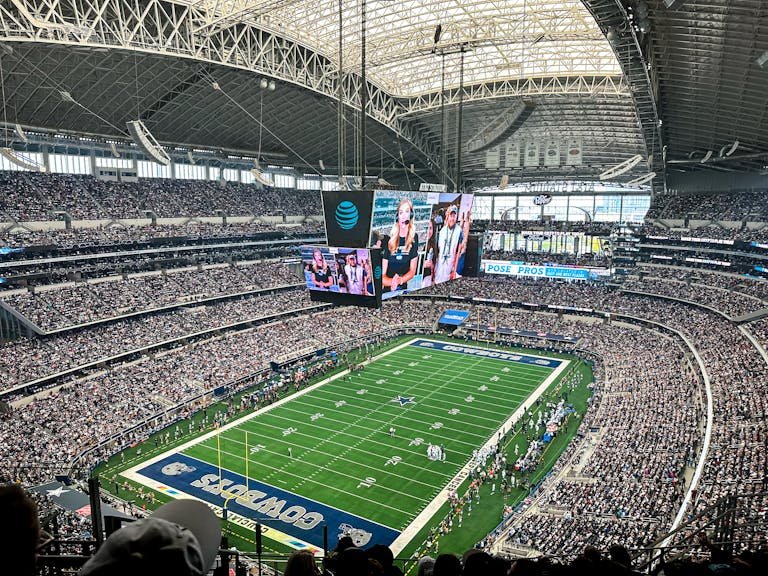A packed AT&T Stadium in Arlington, Texas, showcasing a thrilling football game with enthusiastic fans.