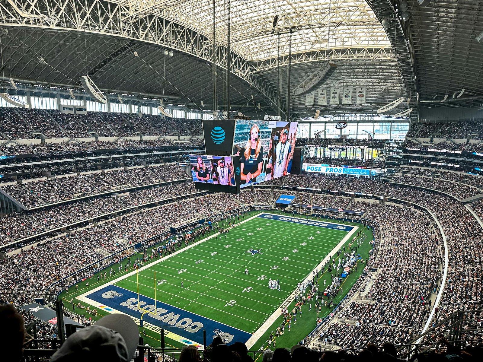 A packed AT&T Stadium in Arlington, Texas, showcasing a thrilling football game with enthusiastic fans.