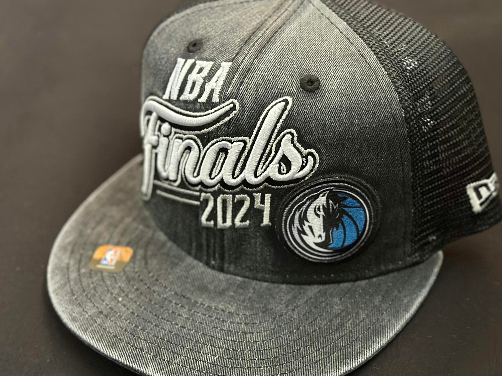 Close-up of a 2024 NBA Finals cap with Dallas Mavericks logo, perfect for sports enthusiasts.