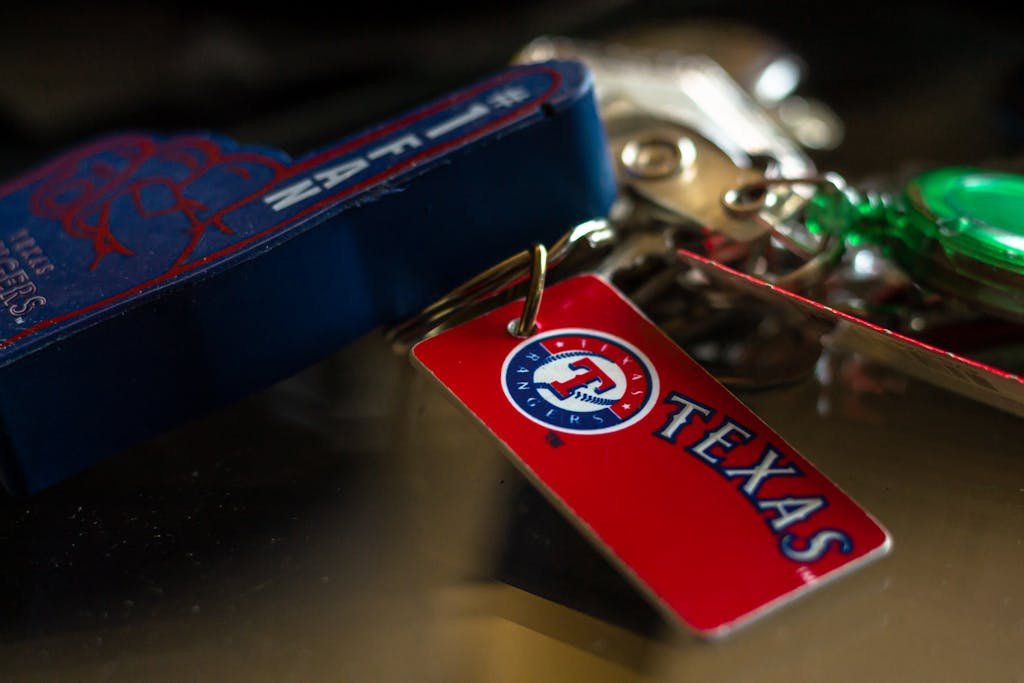 Detailed close-up of a Texas Rangers keychain featuring vibrant colors and logo.