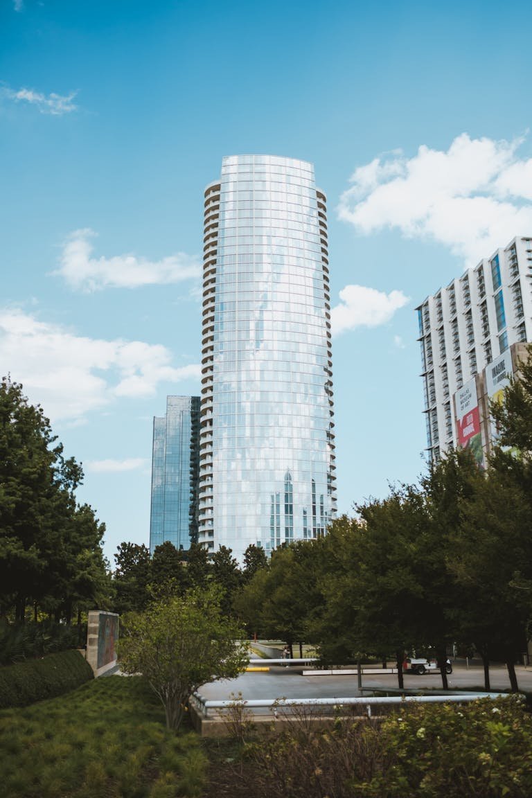 Stunning view of a modern skyscraper amidst trees in Dallas, Texas.